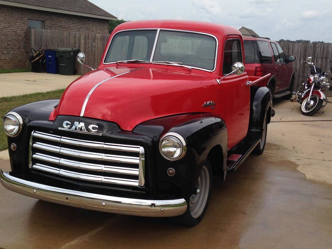 GMC truck restoration featuring red and black paint.